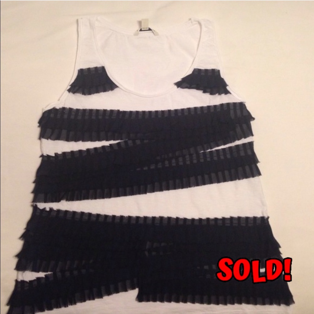 White top with navy pleated ruffles.